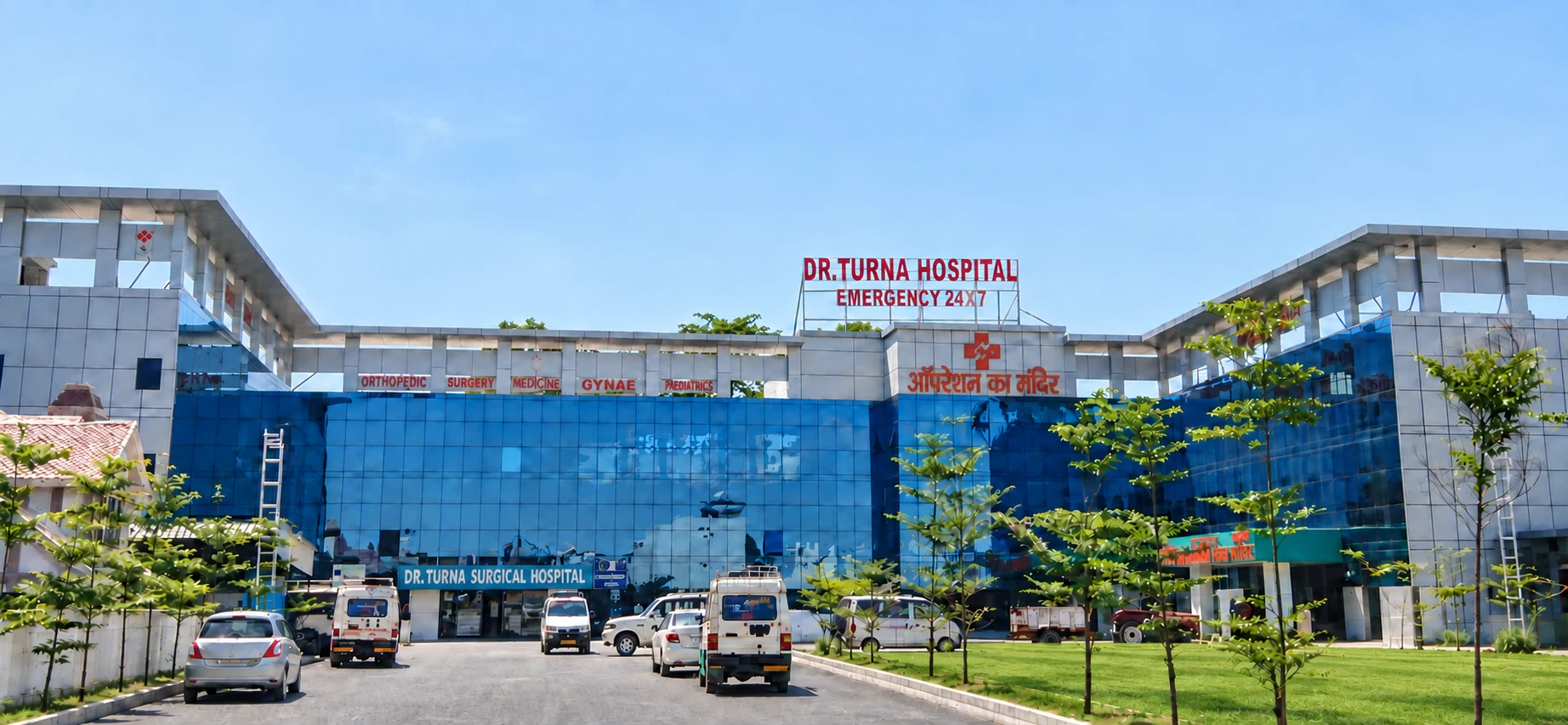 Digitally enhanced view of Turna Hospital with a landscaped lawn and paved approach